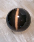 Black Cat’s Eye or Dark/Oxidized Tiger’s Eye.
