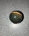 Black Cat’s Eye or Dark/Oxidized Tiger’s Eye.